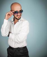Luxury man in sunglasses and white shirt looking away photo