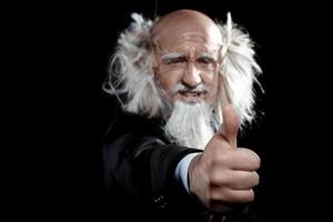 old man shows gesture of class in studio photo