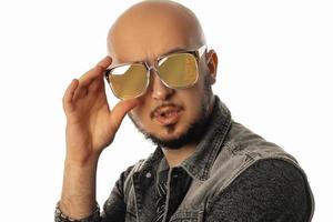 Adorable unshaved man in sunglasses posing on camera with opened mouth photo