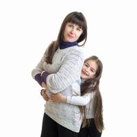 little girl hugs her mother and smiling photo