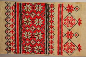Detail Ukrainian ethnic ornament towel, embroidered good by cross-stitch pattern, close up photo