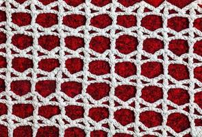 Vintage white lace on red background closeup photo