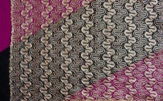 Beige openwork lace on a black-burgundy background photo