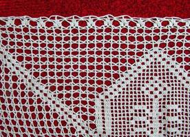 Vintage white lace on red background closeup photo