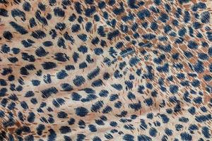 Background with leopard texture, close up. Leopard dyed fabric. photo