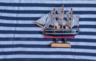 Ship on the background marine textile texture for the background. Close-up of a marine textile texture with blue and white stripes. photo