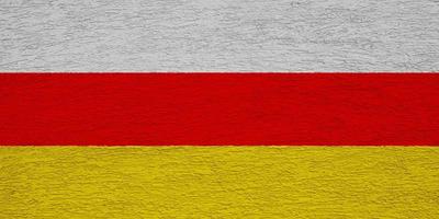 Flag of South Ossetia on a textured background. Concept collage. photo