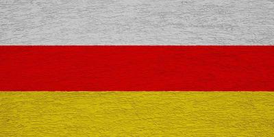 Flag of South Ossetia on a textured background. Concept collage. photo