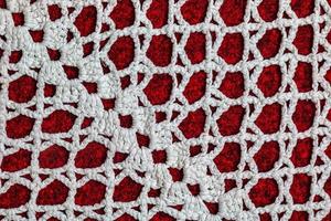 Vintage white lace on red background closeup photo