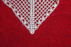 Vintage white lace on red background closeup photo