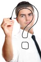 Businessman drawing a Question mark photo