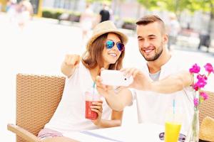 Happy couple taking pictures in a cafe photo