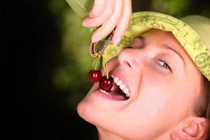 Woman eating cherries photo