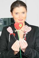 young businesswoman with heart-shaped lollipops photo