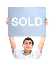 Man carrying a Sold sign photo