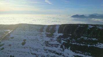 Beautiful landscape with mountains and fog clouds, drone flying around the mountain top video