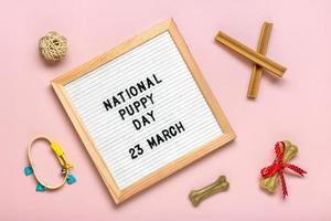 Felt board with text National puppy day in 23 march Greeting card photo