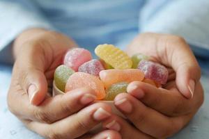 women holding a bowl of gummy colorful candies photo