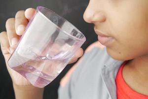 teenage boy drinking water close up photo