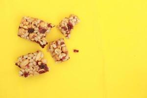 Almond and oat protein bars on yellow background photo