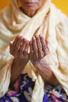 Close up of senior women hand praying at ramadan photo