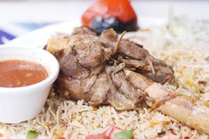 mutton biryani meal in a plate on table. photo