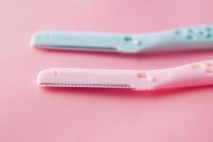 color plastics woman razors and shaving blade on table photo