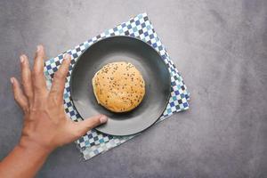 top view of hand reaching for a burger photo