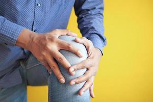 Close up on man suffering knee joint pain photo