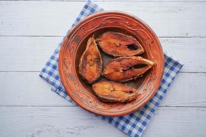 close up of cooked ilsha fish on plate on table photo