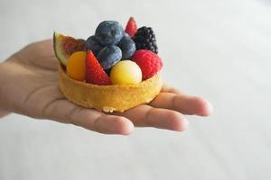 women eating berry fruit tart photo