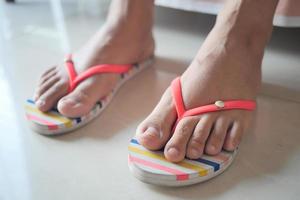 top view of girls feet wearing sandal at early morning photo