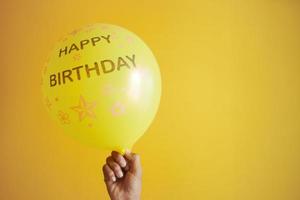 happy birthday test on yellow color Balloons photo