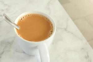 close up of cup of milk tea on table photo