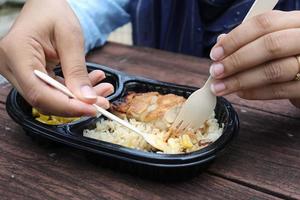 curry chicken and rice in a take away plastic packet on table photo