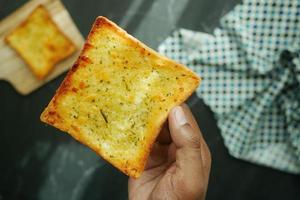 pov shot of holding a garlic bread photo