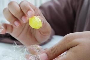 women holding a lemon candy close up photo