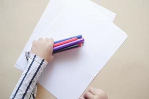 child girl holding many color pencils photo