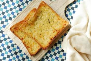 garlic bread on a plate on table photo