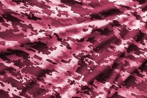 Fabric with texture of Ukrainian military pixeled camouflage. Cloth with camo pattern in grey, brown and green pixel shapes. Image toned in Viva Magenta, color of the year photo