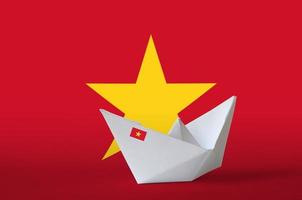 Vietnam flag depicted on paper origami ship closeup. Handmade arts concept photo