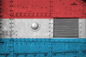 Luxembourg flag depicted on side part of military armored tank closeup. Army forces conceptual background photo