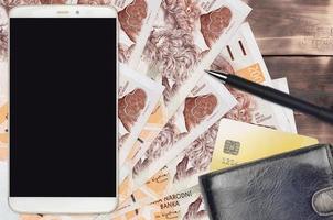 200 Czech korun bills and smartphone with purse and credit card. E-payments or e-commerce concept. Online shopping and business with portable devices photo