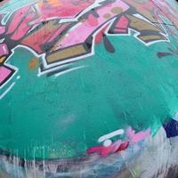 Fragment of a beautiful graffiti pattern in pink and green with a black outline. Street art background image photo