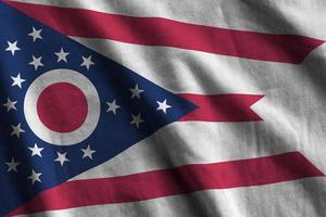 Ohio US state flag with big folds waving close up under the studio light indoors. The official symbols and colors in banner photo
