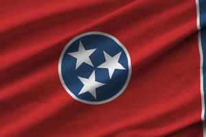 Tennessee US state flag with big folds waving close up under the studio light indoors. The official symbols and colors in banner photo