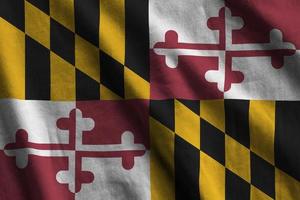 Maryland US state flag with big folds waving close up under the studio light indoors. The official symbols and colors in banner photo