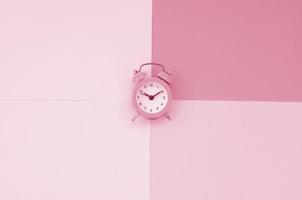 Time to choose metaphor concept. Alarm clock at the crossroads of different colors Image toned in Viva Magenta, color of the 2023 year photo