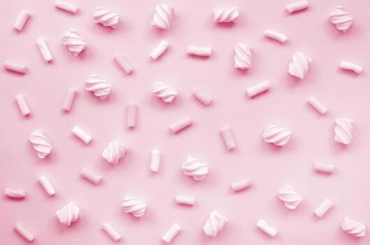 Colorful marshmallow laid out on paper background. pastel Image toned in Viva Magenta, color of the 2023 year photo