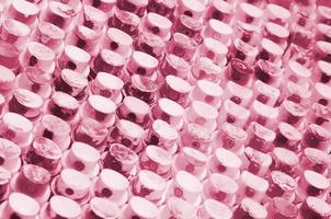 A pattern from a many nozzles from a paint sprayer for drawing graffiti, smeared into different colors. Image toned in Viva Magenta, color of the year photo